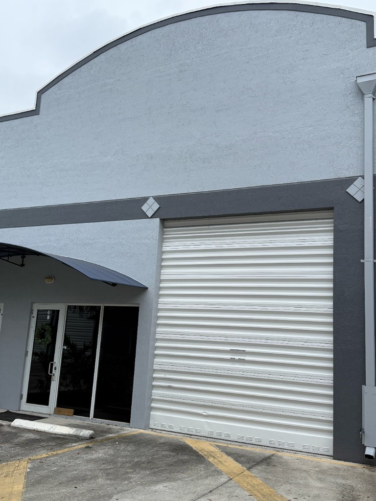Building exterior with roll-up door and secure entry
